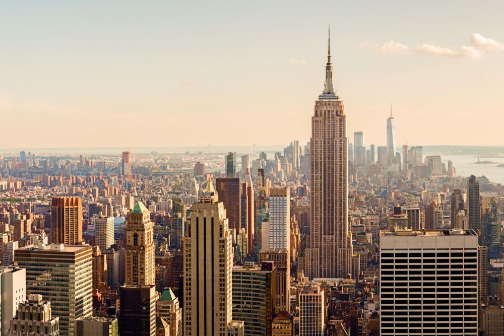 New York City skyline featuring the Empire State Building under a clear sky.