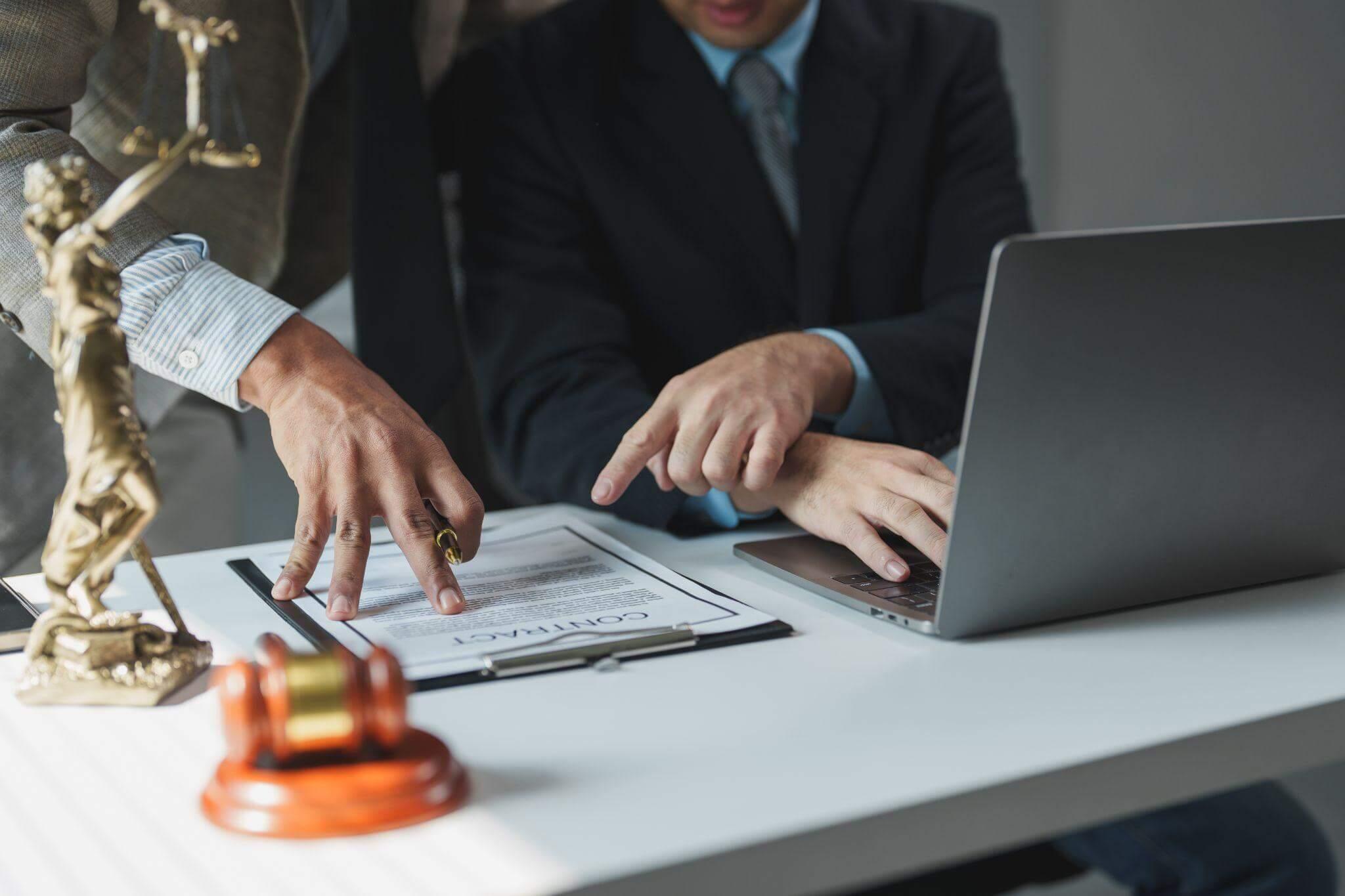 Business professional in suit using laptop